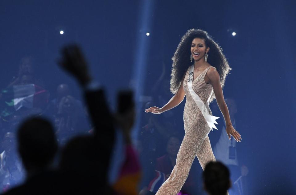 Cheslie Kryst walks on stage during the 2019 Miss Universe pageant (AFP via Getty Images)