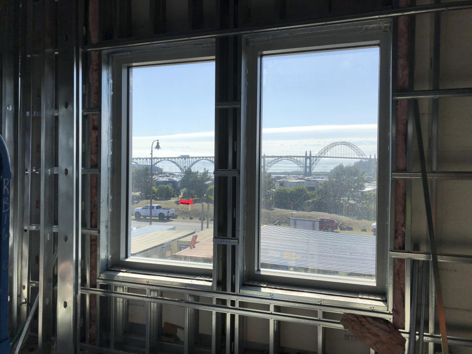 In this July 22, 2019, photo, the Yaquina Bay Bridge is seen through the window of Oregon State University's Marine Studies Building, which is being erected in a tsunami inundation zone in Newport, Ore. Experts say there is a 37 percent chance that a large Cascadia earthquake will occur off Oregon's shore in the next 50 years, generating a tsunami that will hit many coastal towns. (AP Photo/Andrew Selsky)