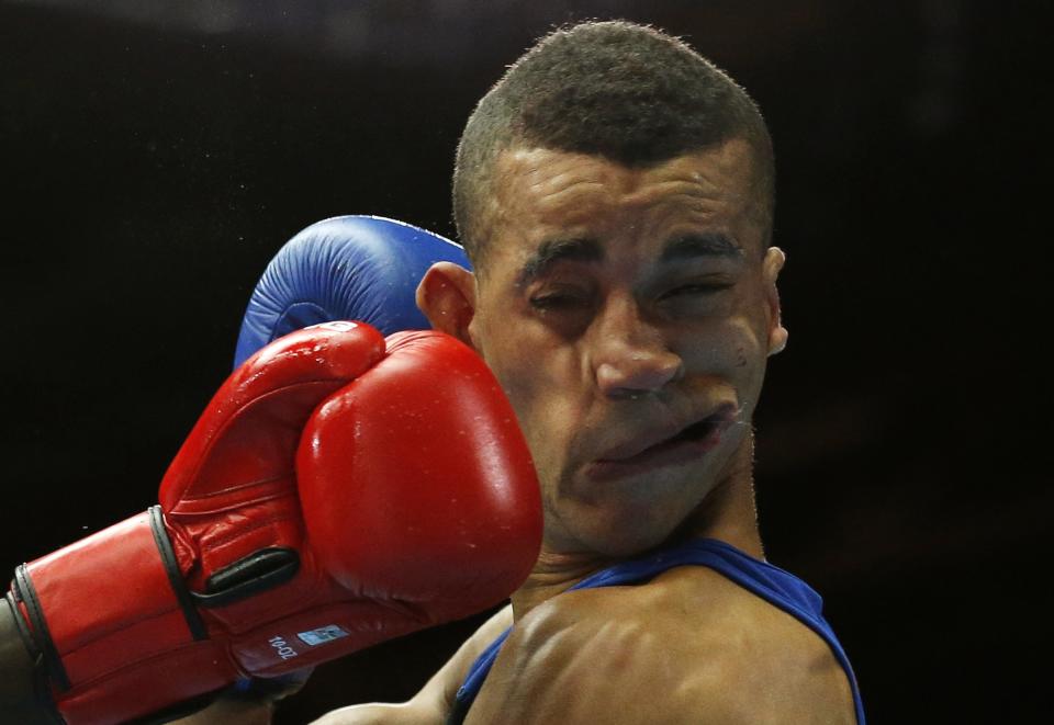 Kenya's Denis Okoth lands a punch on England's Samuel Maxwell during their men's Light Welterweight boxing fight at the Commonwealth Games in Glasgow, Scotland, in this July 27, 2014 file photo. REUTERS/Jim Young/Files (BRITAIN - Tags: SPORT BOXING TPX IMAGES OF THE DAY)