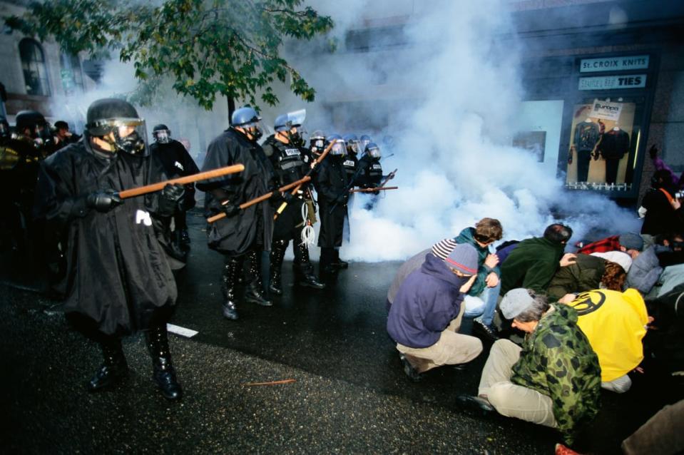 <div class="inline-image__caption"><p>Protesters sitting on the ground are confronted by riot police during the World Trade Organization’s 1999 conference in Seattle. </p></div> <div class="inline-image__credit">Christopher J. Morris/Corbis via Getty Images</div>