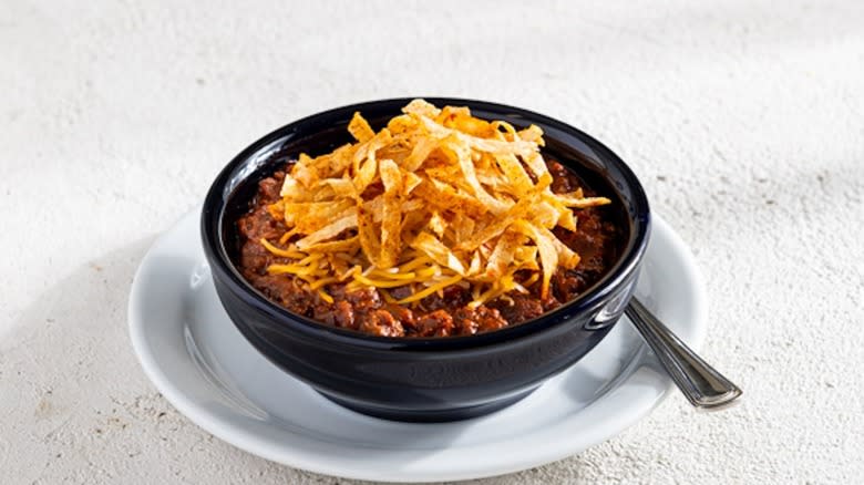 Bowl of chili with tortilla strips on top