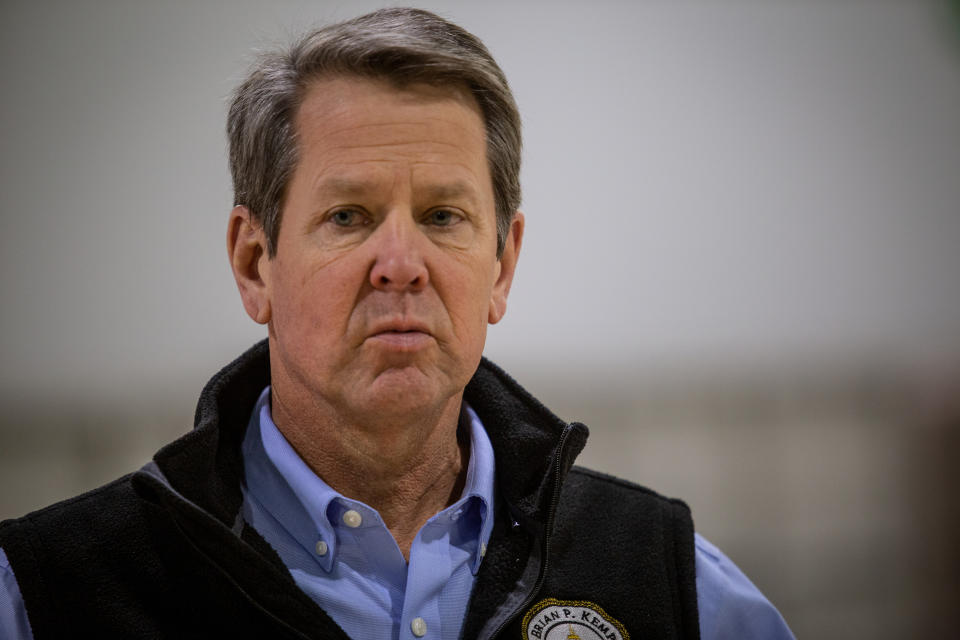 In this April 16, 2020, photo, Georgia Gov. Brian Kemp listens to a question from the press during a tour of a massive temporary hospital at the Georgia World Congress Center in Atlanta. (AP Photo/Ron Harris, Pool)