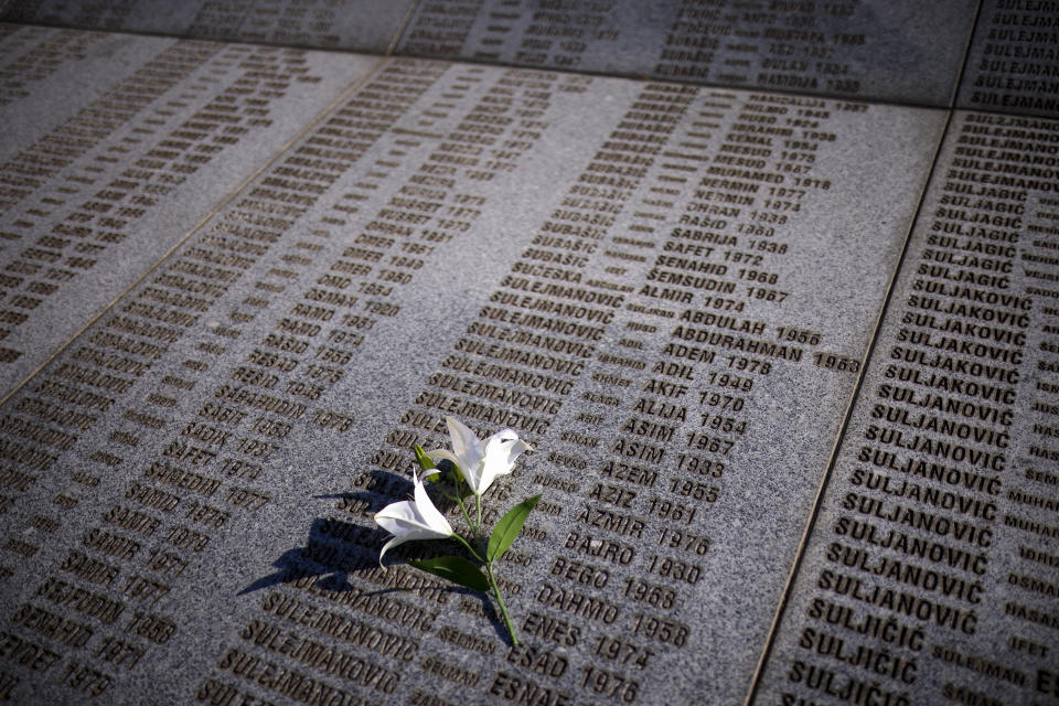 Flowers are placed on the monument with names of those killed in Srebrenica genocide, at the Srebrenica Memorial Centre, in Potocari, Bosnia, Thursday, July 11, 2024. Thousands gathered in the eastern Bosnian town of Srebrenica to commemorate the 29th anniversary on Monday of Europe's only acknowledged genocide since World War II. (AP Photo/Armin Durgut)