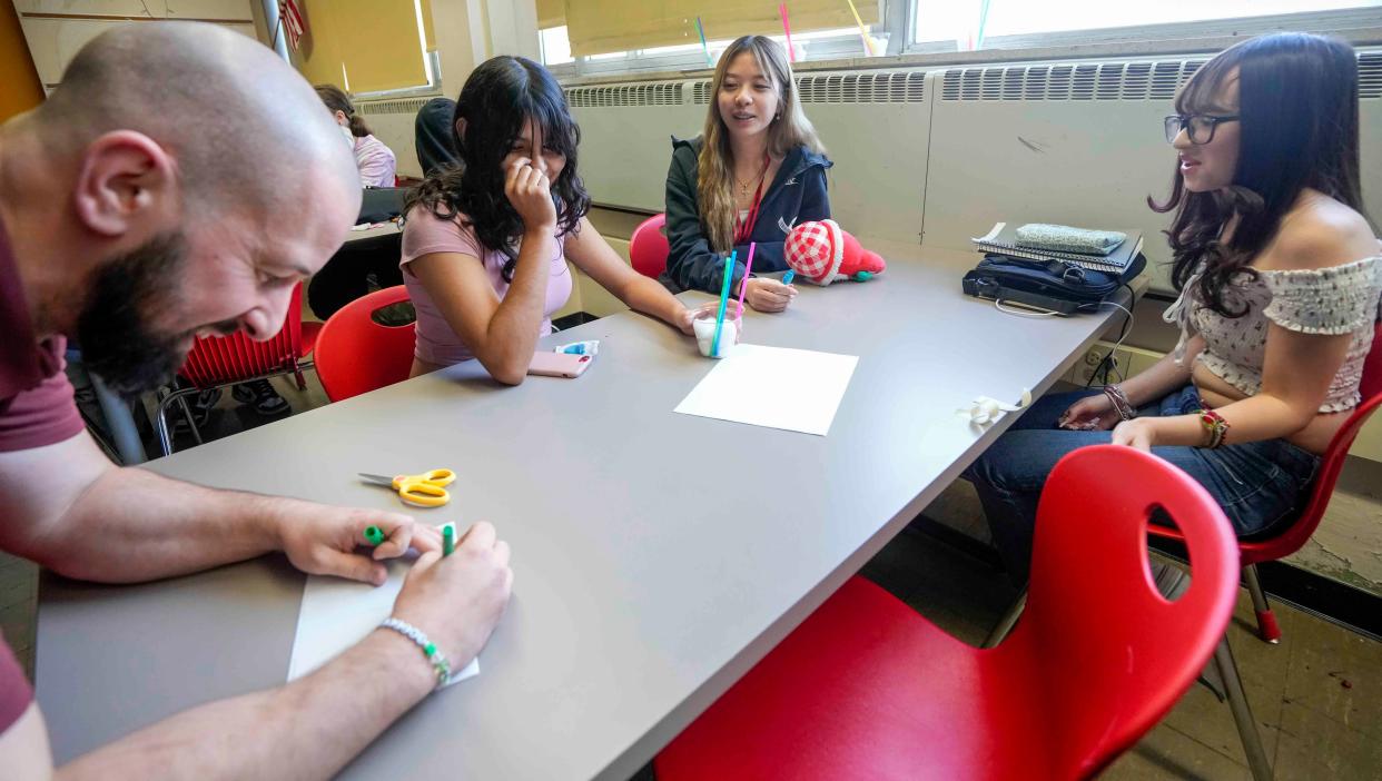 Restorative Practices teacher Andrew Lazzari writes down the name of a group's egg in a group activity Nov. 27 at Audubon High School, 3300 S. 39th St., Milwaukee. The goal was to find a way to protect the egg using a few materials when dropped from a certain distance.