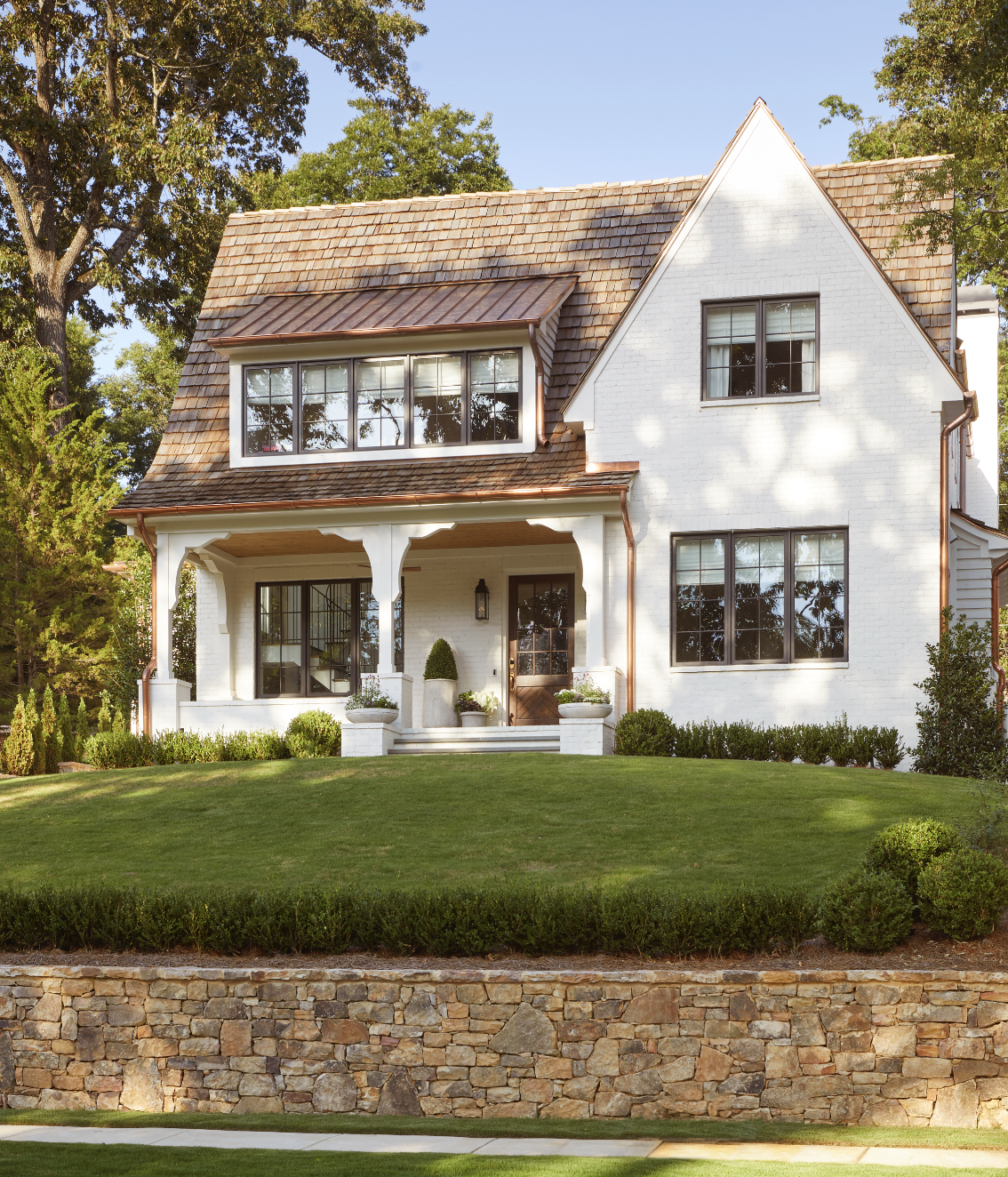 a white house with a stone wall