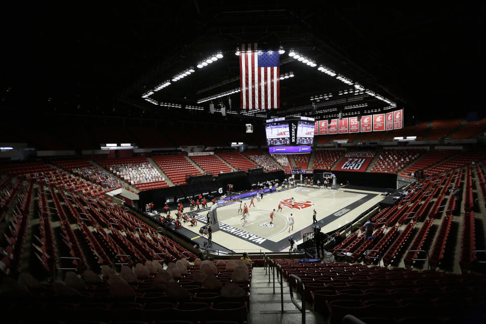 FILE - Washington State and Utah play the first half of an NCAA college basketball game at Beasley Coliseum without fans present due to the COVID-19 pandemic, in Pullman, Wash., in this Thursday, Jan. 21, 2021, file photo. Since the season began Nov 25, more than 715 men’s basketball games have been postponed, rearranged or simply called off, according to an AP analysis through Friday's, Feb. 5, 2021, games, and the news was similar for women's teams. (AP Photo/Young Kwak, File)