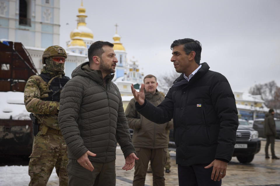 In this photo provided by the Ukrainian Presidential Press Office, Ukrainian President Volodymyr Zelenskyy, left, and British Prime Minister Rishi Sunak talk as they observe destroyed Russian military vehicles installed in downtown Kyiv, Ukraine, Saturday, Nov. 19, 2022. (Ukrainian Presidential Press Office via AP)
