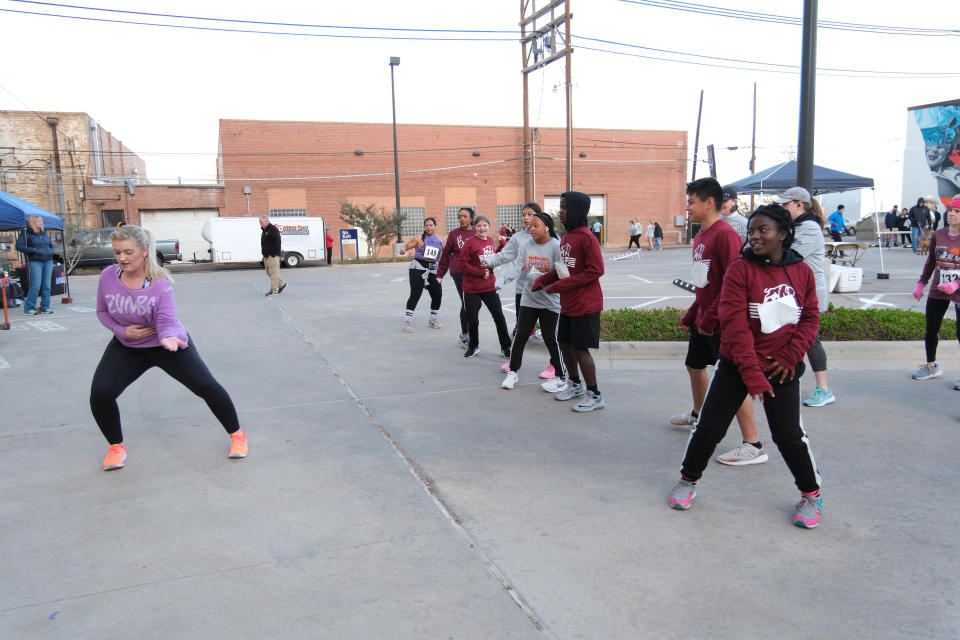 Runners get stretched out doing Zumba Saturday morning before the 2nd annual Center City Mural Run in downtown Amarillo.