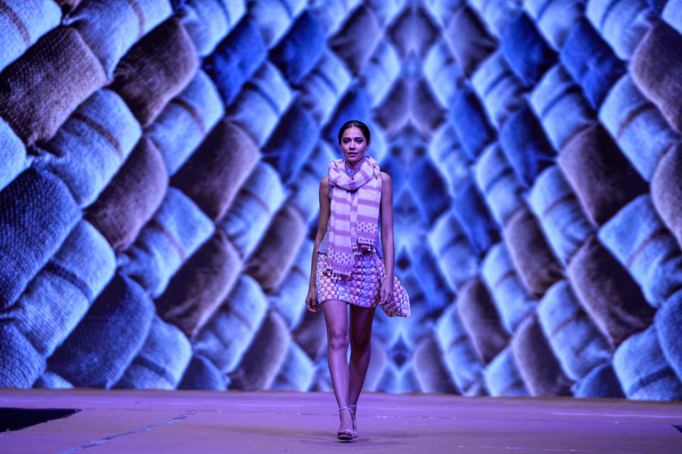 A model showcases Sujani weaving and Kala Cotton craft during a fashion show in Ahmedabad, India, Sunday, March 3, 2024. (AP Photo/Ajit Solanki)