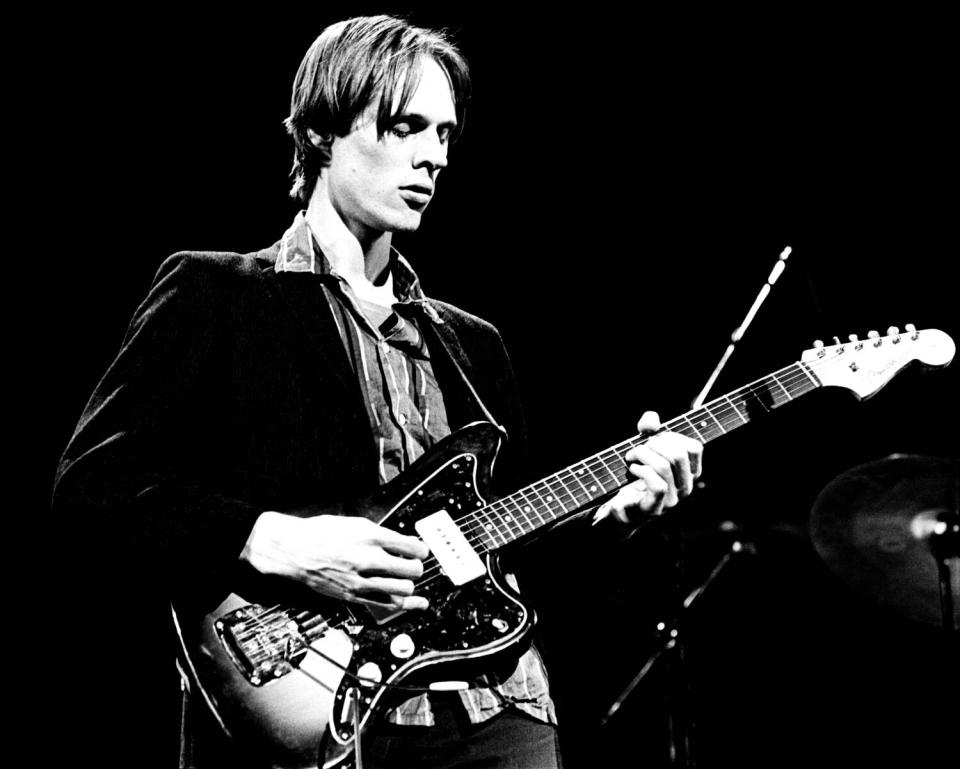 A man playing electric guitar onstage