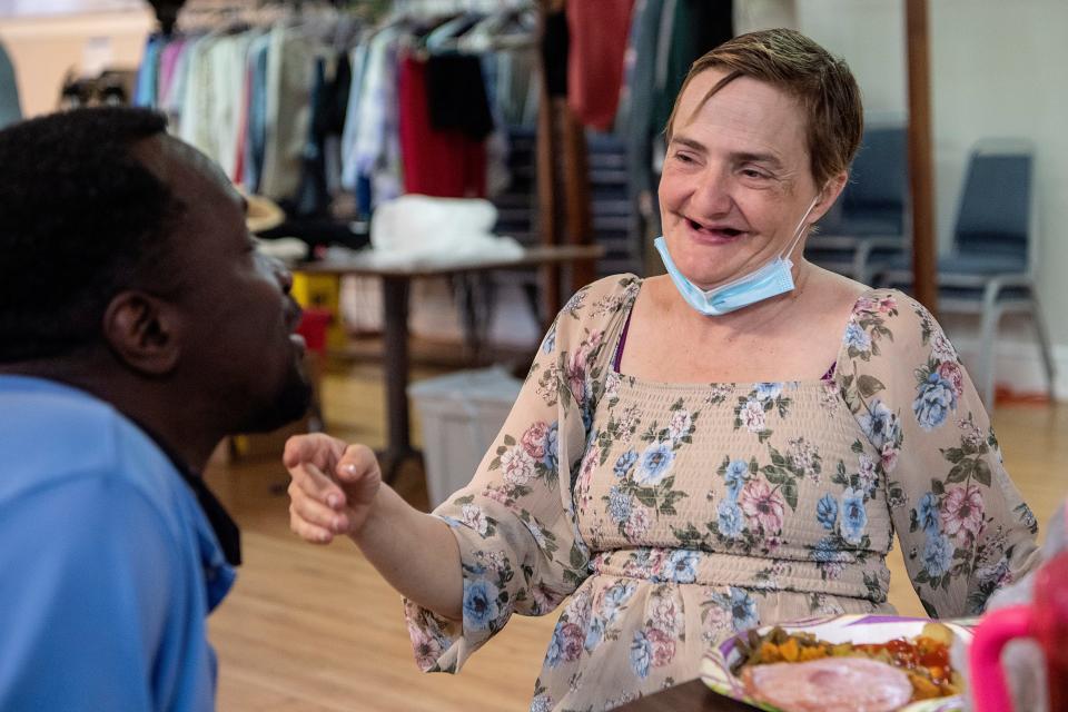 Khristie and Jeffery Glenn laugh with one another as they eat dinner at Trinity Methodist Church March 31, 2022.