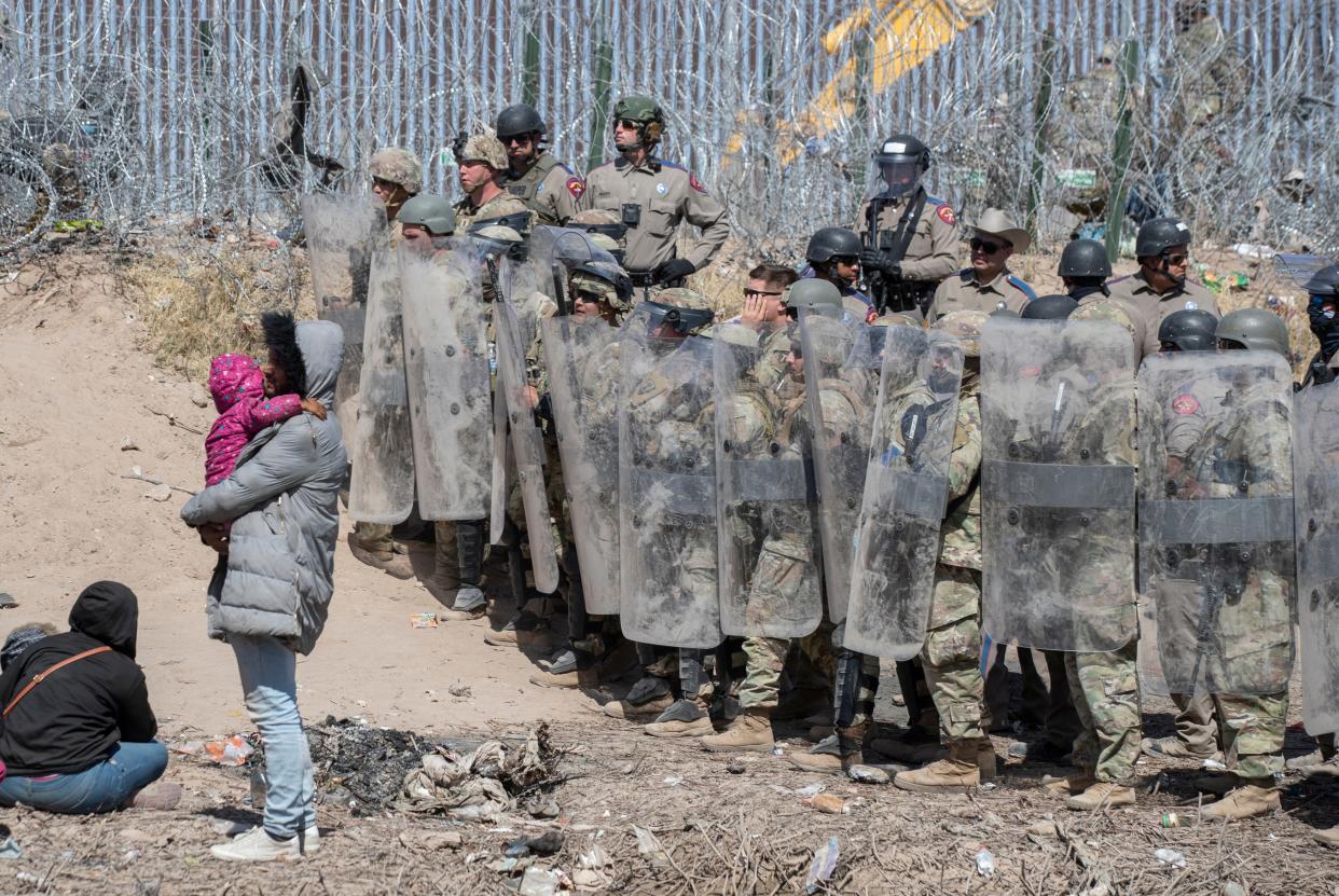 Texas National Guard and Texas State Troopers use anti-riot gear to prevent asylum seekers from entering further into U.S. territory after the migrants crossed the Rio Grande into El Paso, Texas from Ciudad Juarez, Mexico on March 22, 2024.