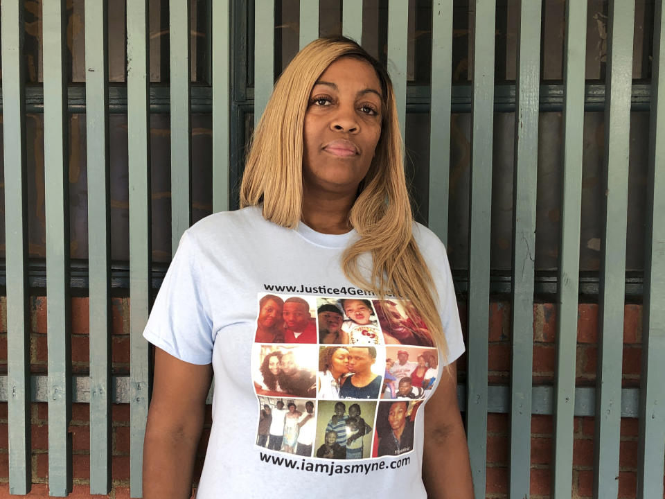 In this Sept. 25, 2019 photo, LaTisha Nixon poses for a photo, wearing a T-shirt adorned with photos of her son Gemmel Moore, one of the men who died in the apartment of Democratic donor Ed Buck, at a news conference in West Hollywood, Calif. It took more than two years from the first overdose death in political donor Ed Buck's apartment until his arrest this month. In the time in between, another man died in the West Hollywood home, another had a close brush with death and several others reporting harrowing encounters with the gay white man who preyed on young black men to satisfy a drug-fueled sexual fetish. Activists who pushed for Buck's arrest wonder why it took so long to lock him up. (AP Photo/Brian Melley)