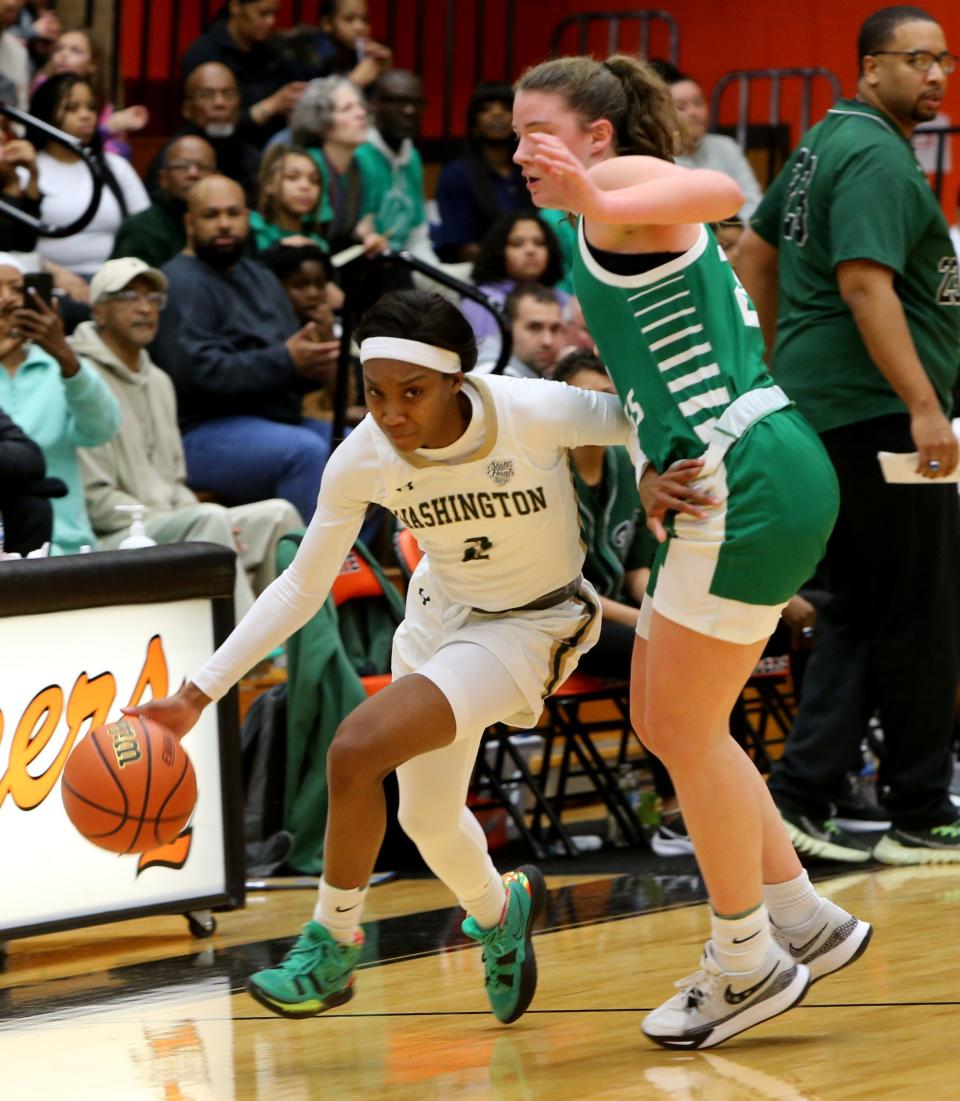 Washington's Rashunda Jones (2) drives against Valparaiso's Lillian Barnes (23) Saturday, Feb. 11, 2023, at the girls 4A basketball regional game at LaPorte High School. Washington won, 60-41, to advance.