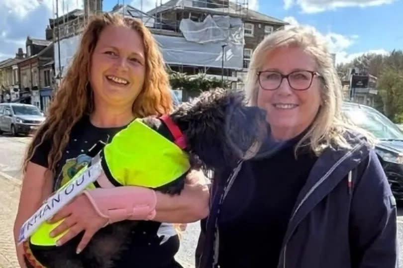Ally Young (left) holding a dog posing with Susan Hall (right)