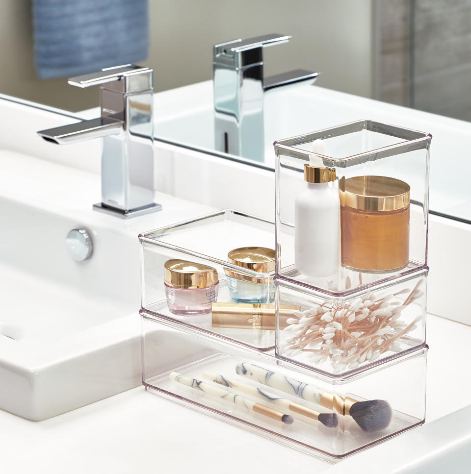 Photo of clear canisters on the bathroom sink