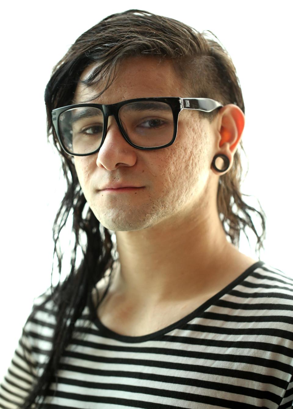 In this Thursday, March 6, 2014 photo, electronic music DJ and producer, Skrillex, whose real name is Sonny Moore, poses for a portrait in Los Angeles. The 26-year-old Grammy Award winner's first official album, "Recess," is out on Tuesday, March 18, 2014. It was recorded as he toured the world and unfettered by corporate rules. (Photo by Matt Sayles/Invision/AP)