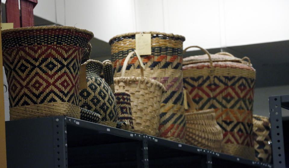 In this Oct. 11, 2013 photograph, Mississippi tribes of Native American-made baskets line the tops of shelves in storage and will be among the items that will eventually be displayed in one of two museums planned for Jackson, Miss. Officials say they did not set out to have separate-but-equal museums for the documentation of the state's history, but it could end up that way. Mississippi breaks ground Thursday. Oct. 24, 2013, on side-by-side museums that are expected to break ground of their own in how they depict the Southern state once rocked by racial turmoil. (AP Photo/Rogelio V. Solis)