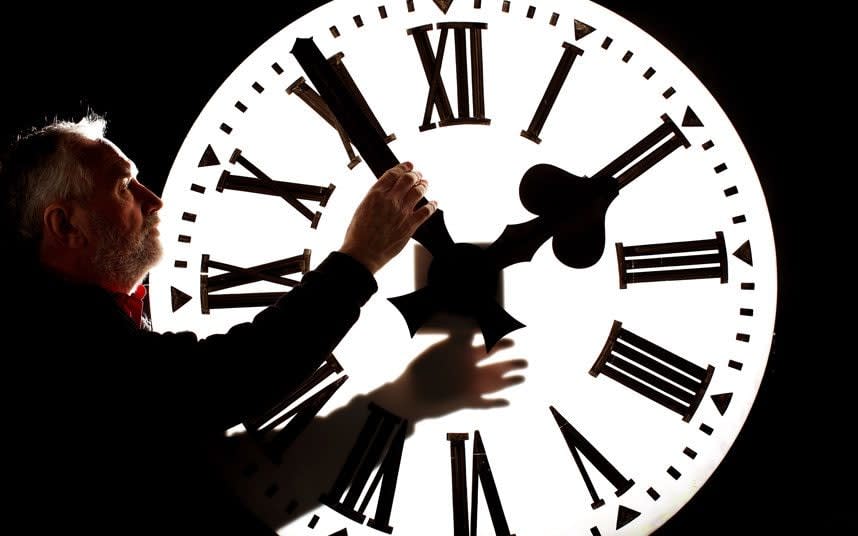 Alan Wilson, Director of James Ritchie & Son clockmakers, founded in 1809, adjusts a clock face to British Summer Time - 2010 Getty Images