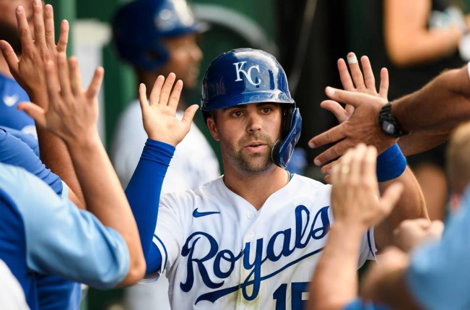 Kansas City Royals Whit Merrifield is greeted by teammates after scoring against the Detroit Tigers during the third inning of a baseball game in Kansas City, Mo., Tuesday, June 15, 2021. (AP Photo/Reed Hoffmann)