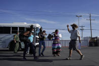 In this Wednesday, Sept. 22, 2021, file photo, a member with the Border Humanitarian Coalition, right, guides migrants, mostly from Haiti, as they are released from United States Border Patrol custody upon crossing the Texas-Mexico border in search of asylum in Del Rio, Texas. (AP Photo/Julio Cortez, File)