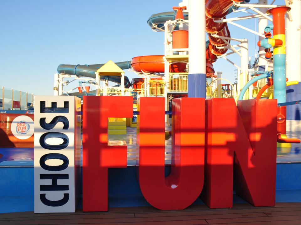 The top deck of a cruise ship with a large sign that says 'Choose fun.'