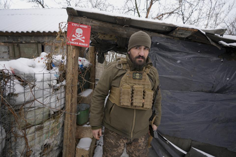 An Ukrainian serviceman looks around as he leaves a shelter on the front line in the Luhansk region, eastern Ukraine, Friday, Jan. 28, 2022. High-stakes diplomacy continued on Friday in a bid to avert a war in Eastern Europe. The urgent efforts come as 100,000 Russian troops are massed near Ukraine's border and the Biden administration worries that Russian President Vladimir Putin will mount some sort of invasion within weeks. (AP Photo/Vadim Ghirda)