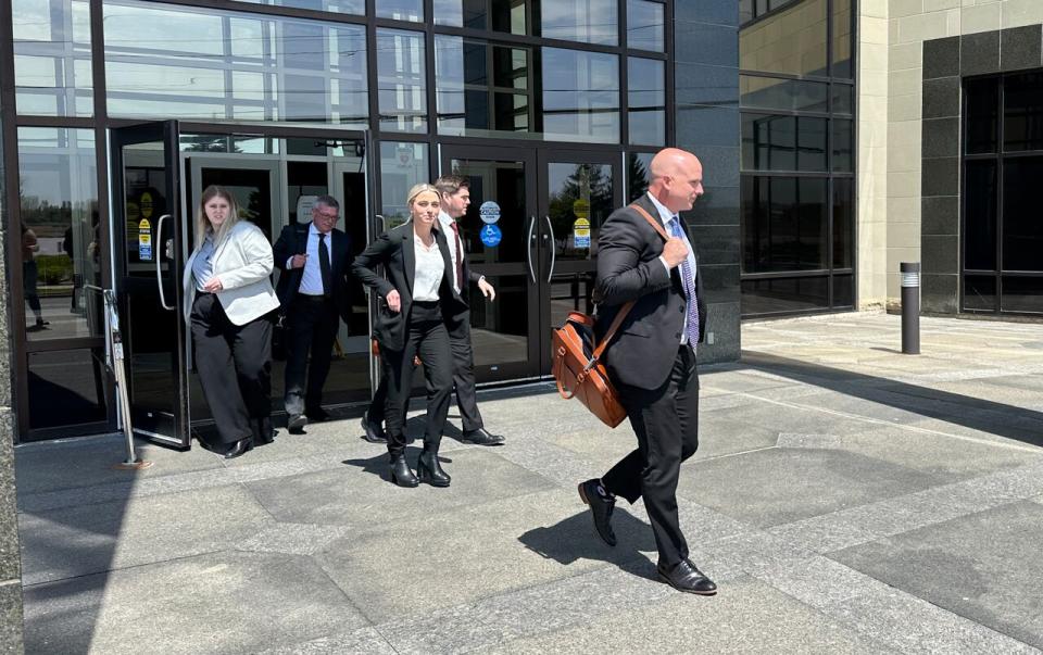 Clarence Bennett, right, a lawyer representing the provincial government leaving the Moncton courthouse on Tuesday. 