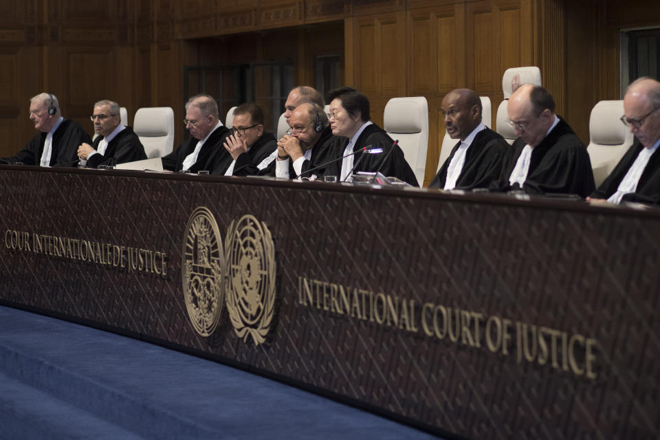 Presiding judge Abdulqawi Ahmed Yusuf of Somalia, third from right, reads the court's verdict as delegations of Iran and the U.S. listen at the International Court of Justice, or World Court, in The Hague, Netherlands, Wednesday, Feb. 13, 2019. The court is scheduled to deliver its judgement on U.S. objections about the court's jurisdiction in the case. (AP Photo/Peter Dejong). (AP Photo/Peter Dejong)