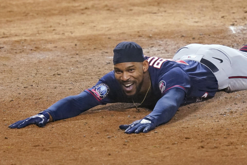 Minnesota Twins' Byron Buxton smiles after scoring on an inside-the-park home run during the third inning of the team's baseball game against the Chicago White Sox on Tuesday, Sept. 15, 2020, in Chicago. (AP Photo/Charles Rex Arbogast)