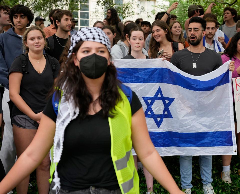 A pro-Palestinian protester walks past pro-Israel counterprotesters during Wednesday's demonstration.