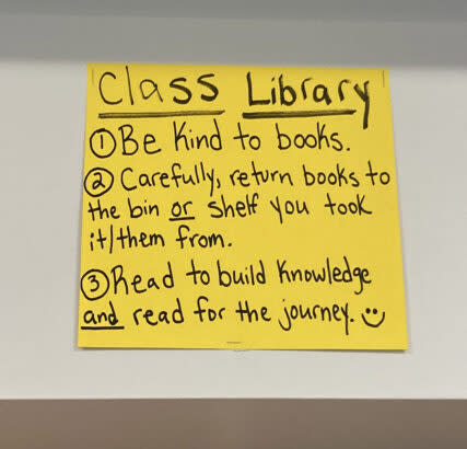 A handwritten sign in Kyair Butts’ classroom urges students to respect the class library. (Greg Toppo)