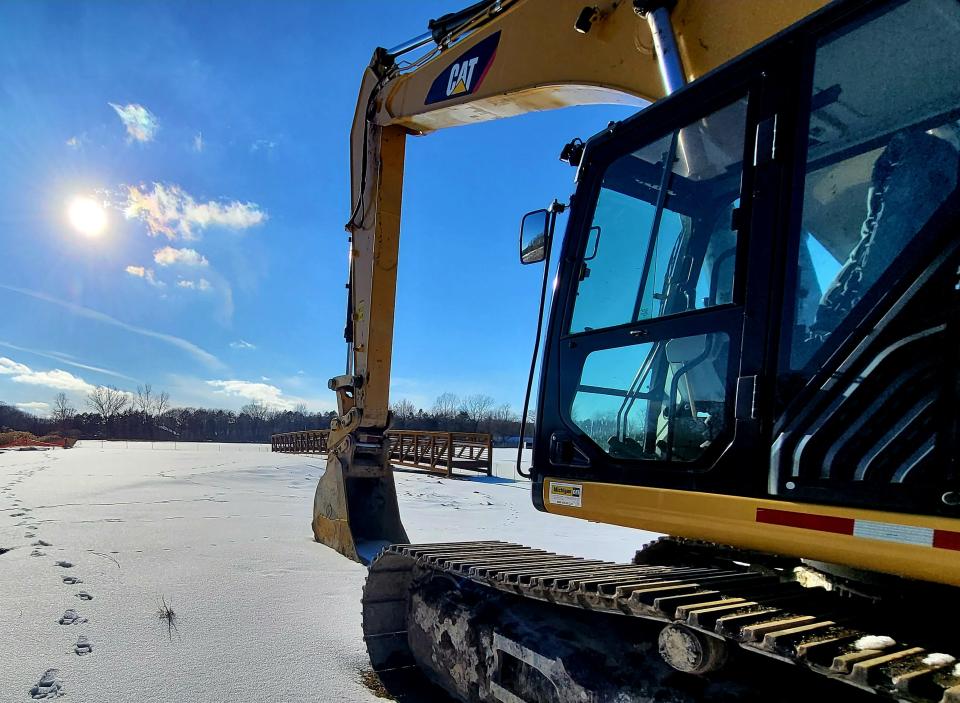 The bridge for a $1.4 million, 10-foot pathway over the Black River Canal — in view of a resting excavator — sits on the waterway's north side on Tuesday, Feb. 28, 2023, in Port Huron.