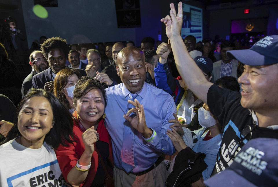 FILE - Bernard Adams, center, brother of New York mayor Eric Adams, mingles with supporters at his brother's election night party, June 22, 2021, in New York. Mayor Adams is seeking approval from city ethics officers to hire his brother, a former New York police officer, as the head of his security detail. (AP Photo/Kevin Hagen, File)