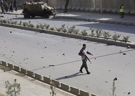 An Afghan security personnel keeps watch at the site of a suicide car bomb blast in Kabul, Afghanistan October 11, 2015. REUTERS/Ahmad Masood