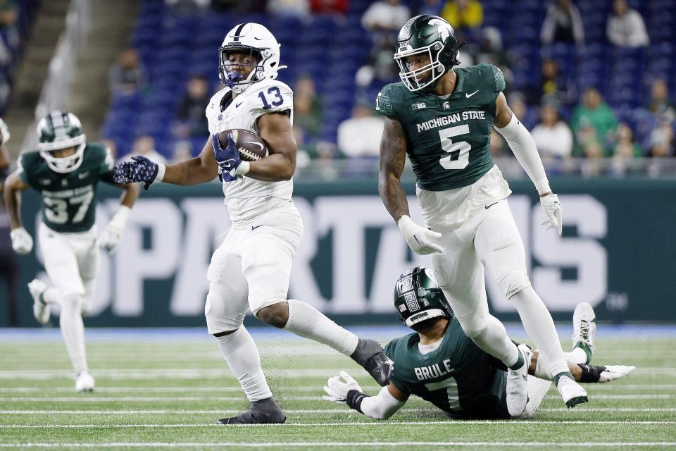 Penn State running back Kaytron Allen breaks a tackle by Michigan State safety Aaron Brule in the fourth quarter of MSU's 42-0 loss on Friday, Nov. 23, 2023, at Ford Field.