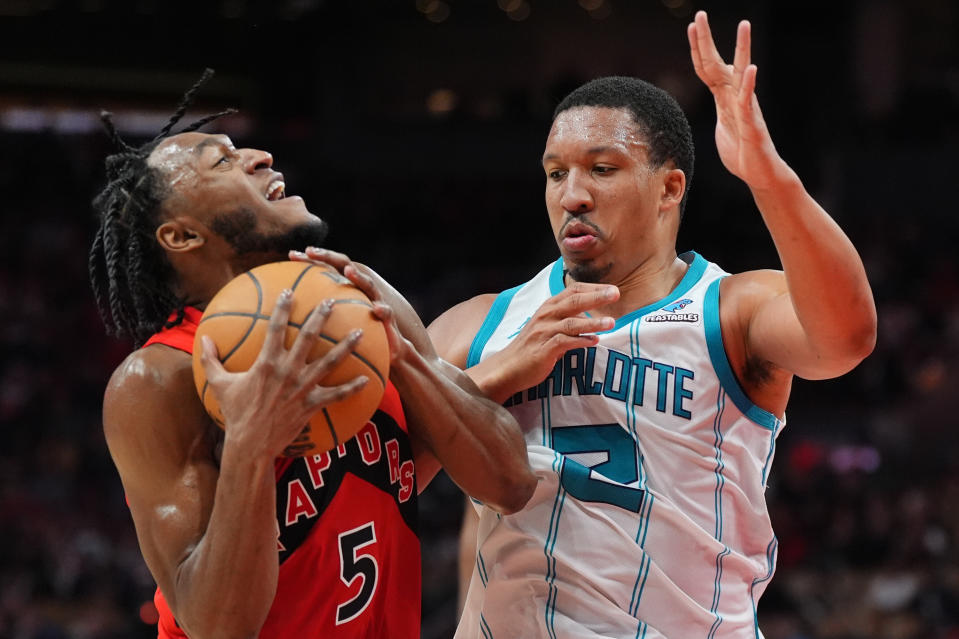 Toronto Raptors guard Immanuel Quickley (5) is fouled by Charlotte Hornets forward Grant Williams (2) during second-half NBA basketball game action in Toronto, Sunday, March 3, 2024. (Frank Gunn/The Canadian Press via AP)