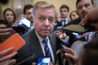 Senate Judiciary Committee Chairman Lindsey Graham, R-S.C., is surrounded by reporters after he and Republican lawmakers met with Attorney General William Barr about expiring provisions of the Foreign Intelligence Surveillance Act and other government intelligence laws, on Capitol Hill in Washington, Tuesday, Feb. 25, 2020. (AP Photo/J. Scott Applewhite)