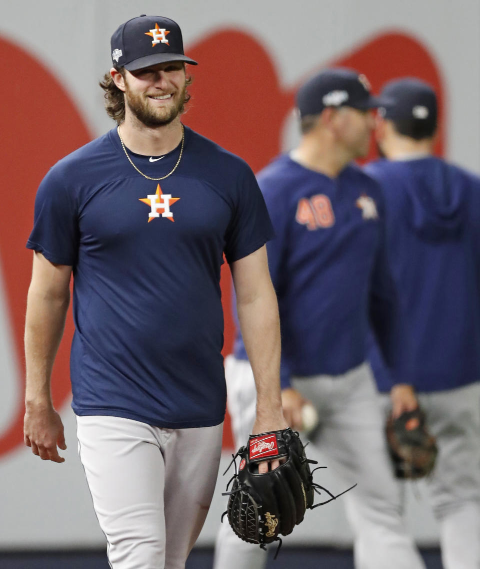 Houston Astros Game 3 starting pitcher Gerrit Cole, left, leaves the field after throwing a brief workout at Yankee Stadium, Monday, Oct. 14, 2019, in New York, after the team arrived to prepare for the American League Championship Series, which continues Tuesday against the New York Yankees.2 (AP Photo/Kathy Willens)