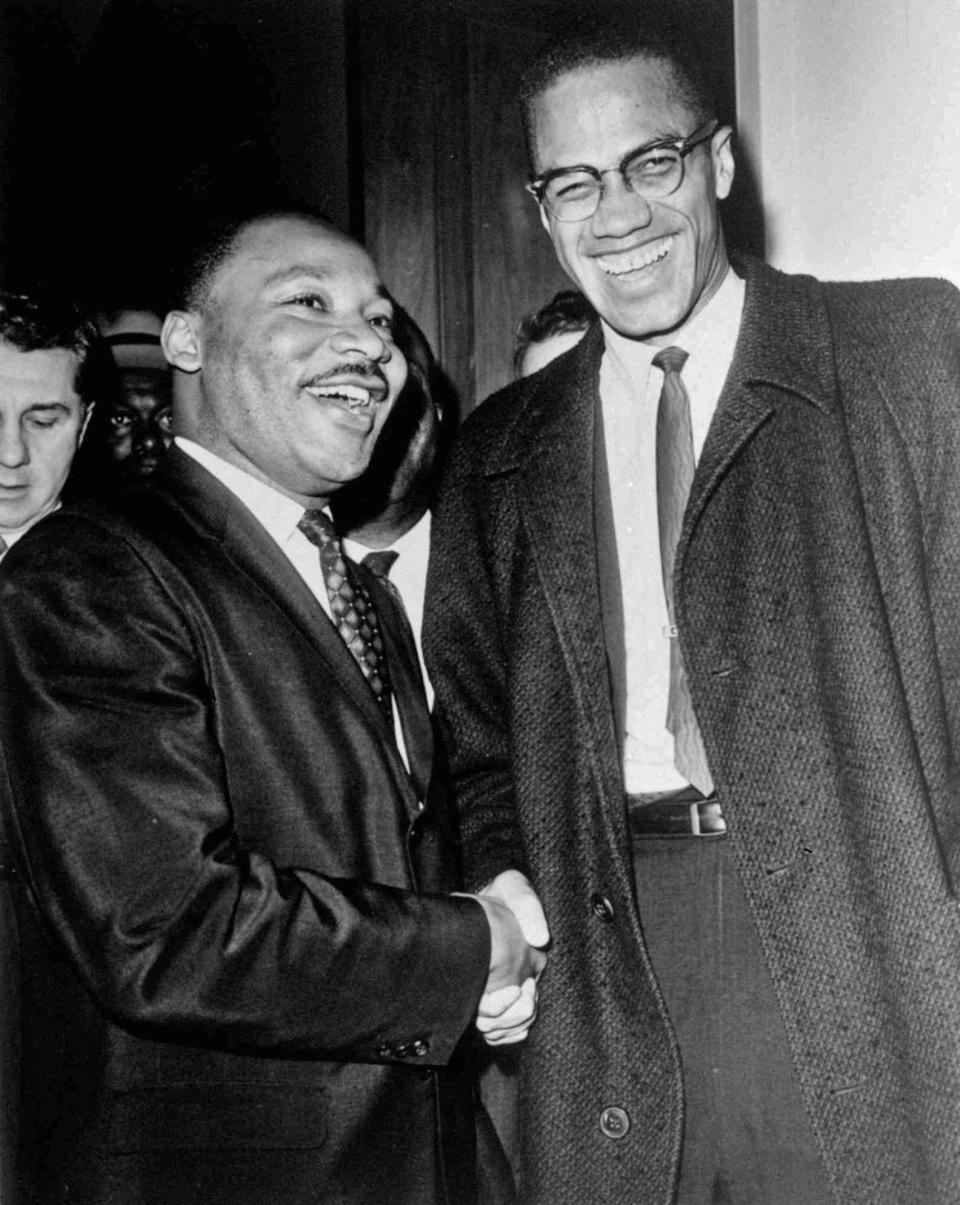 Rev. Martin Luther King Jr., left, of the Southern Christian Leadership Conference, and Malcolm X smile for photographers in Washington on March 26, 1964. They shook hands after King announced plans for direct action protests if Southern senators filibustered against the civil rights bill.