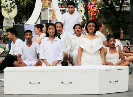 Filipino theatre artists perform, in front of a mock coffin, a short musical about the killings under the Philippine government's anti-drug campaign, in Pandacan city, metro Manila, Philippines April 2, 2017. REUTERS/Romeo Ranoco