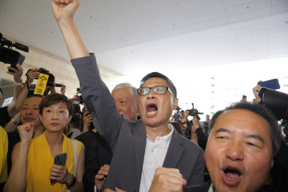 Occupy Central leaders, from left, Tanya Chan, Chan Kin-man and Lee Wing-tat chant before entering a court in Hong Kong, Wednesday, April 24, 2019. The court is preparing to sentence nine leaders of massive 2014 pro-democracy protests convicted last month of public nuisance offenses. The sentences to be handed down Wednesday are seen as an effort by the government of the semi-autonomous Chinese territory to draw a line under the protests. (AP Photo/Kin Cheung)