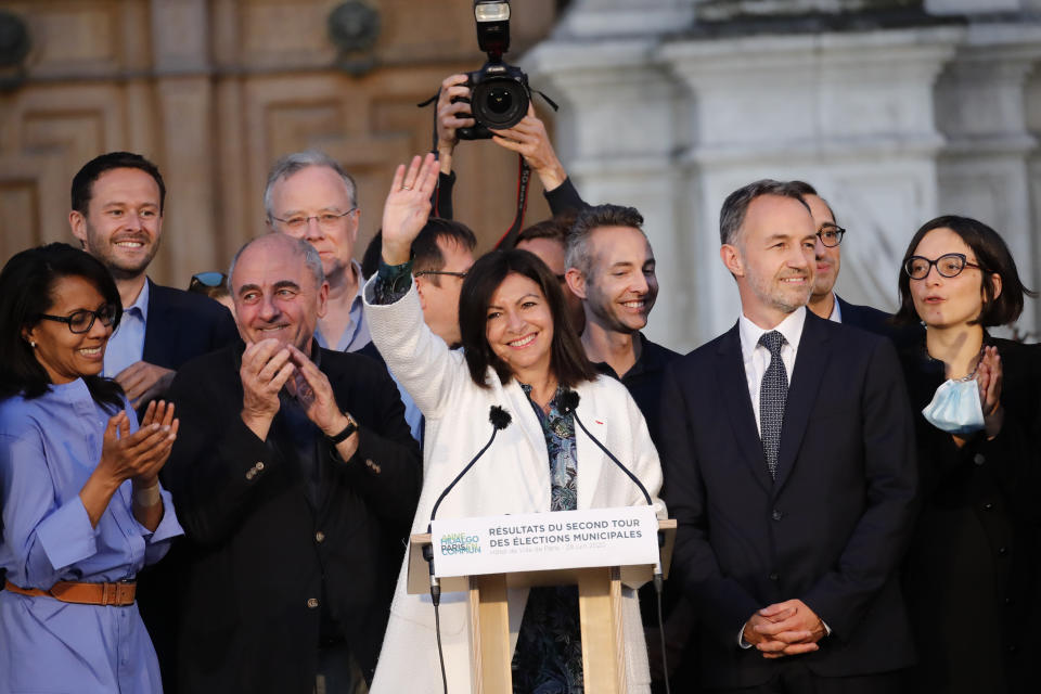 Paris mayor Anne Hidalgo, center, celebrates her reelection after the second round of the municipal election, Sunday, June 28, 2020 in Paris. France on Sunday held the second round of municipal elections that has seen a record low turnout amid concerns over the coronavirus outbreak and anger at how President Emmanuel Macron's government handled it. (AP Photo/Christophe Ena)
