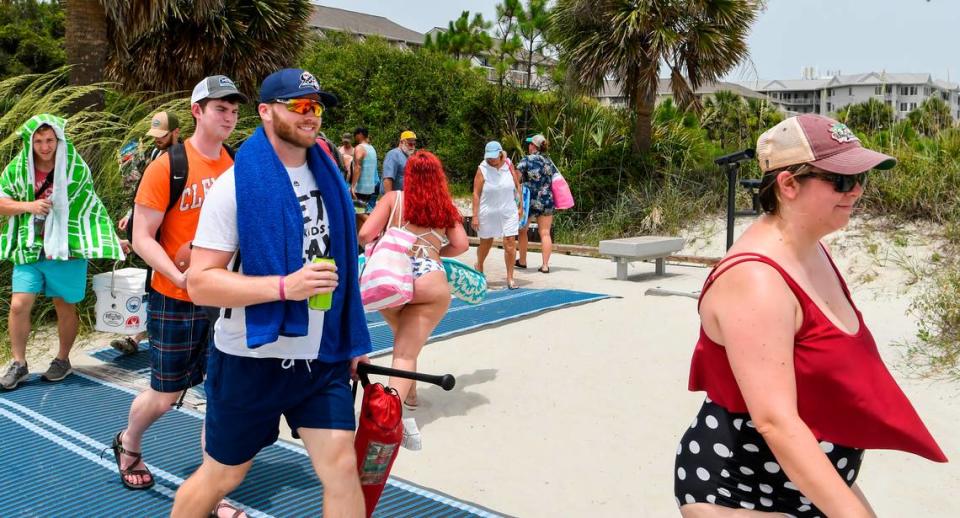 Few beach goers wore face coverings when making their way on and off Hilton Head Island’s beach on Saturday, June 27, 2020 on the narrow pathway near Coligny Beach Park.
