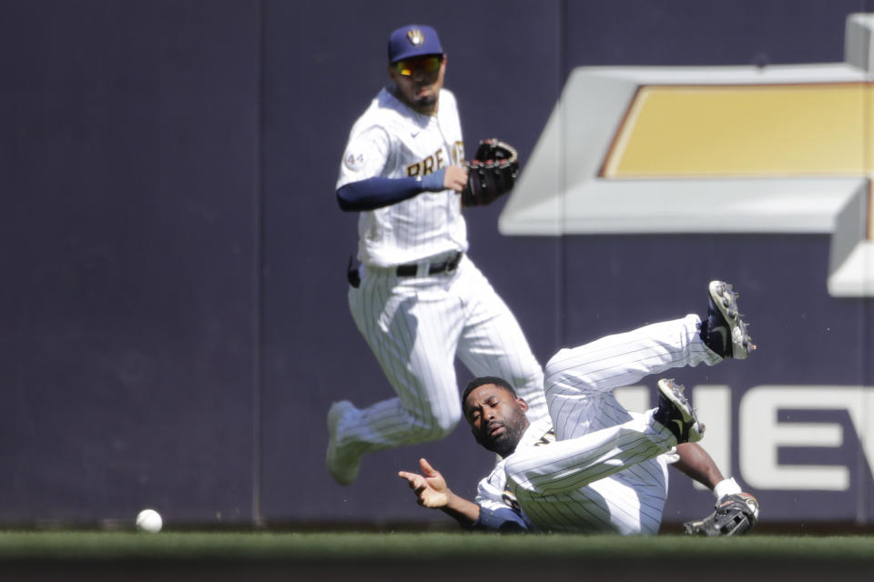 Milwaukee Brewers' Jackie Bradley Jr., right, is unable to make a diving catch during the sixth inning of a baseball game against the Pittsburgh Pirates, Sunday, June 13, 2021, in Milwaukee. (AP Photo/Aaron Gash)