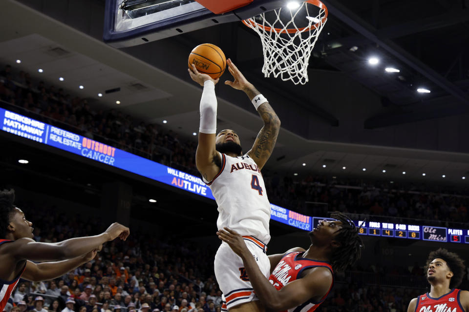 Auburn forward Johni Broome (4) shoots over Mississippi forward Rashaud Marshall during the second half of an NCAA college basketball game Saturday, Jan. 20, 2024, in Auburn, Ala. (AP Photo/Butch Dill)