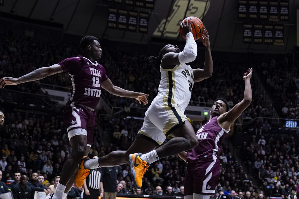 Purdue guard Lance Jones (55) shoots between Texas Southern guard Zytarious Mortle (12) and forward Xavier Ball (35) during the second half of an NCAA college basketball game in West Lafayette, Ind., Tuesday, Nov. 28, 2023. (AP Photo/Michael Conroy)