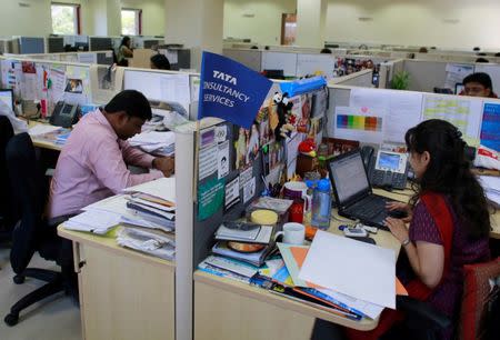 Employees of Tata Consultancy Services (TCS) work inside the company headquarters in Mumbai March 14, 2013. REUTERS/Danish Siddiqui/File Photo