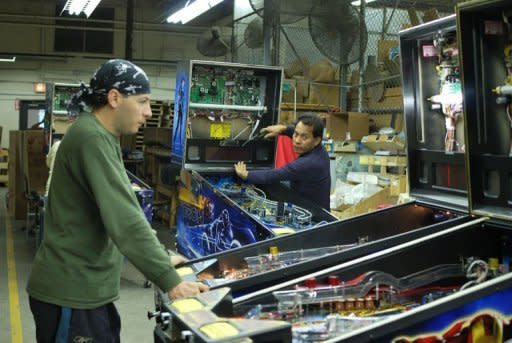 Workers at Stern Pinball assemble Rolling Stones pinball machines in Chicago on August 15, 2011. Stern is the only remaining pinball maker in the world and the company's founder - along with a core group of devoted players - is determined to the keep the game alive