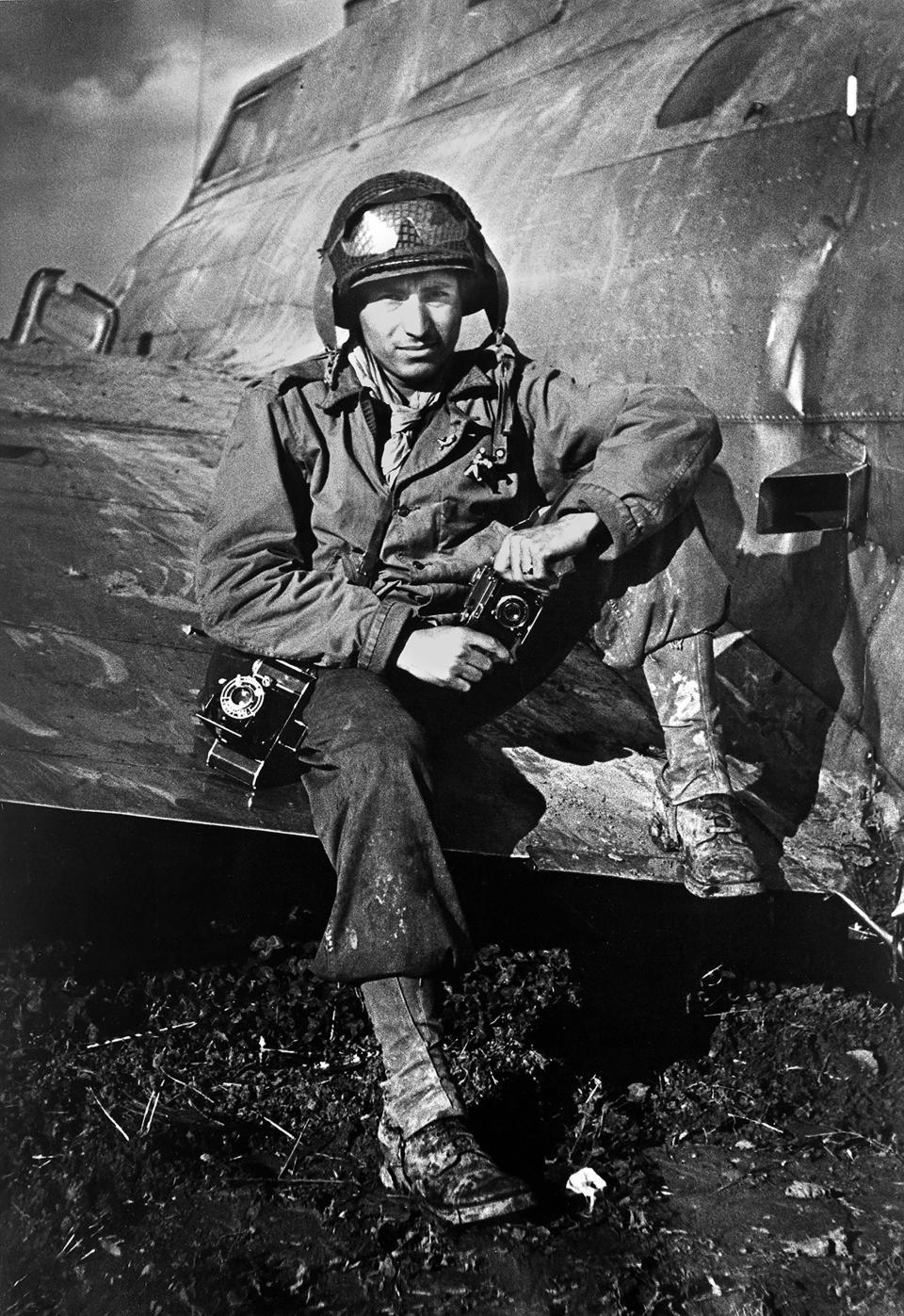 This 1945 photo shows photographer PFC Tony Vaccaro posing for a photo on the wing of an airplane during WWII. Vaccaro, 97, was thrown into WWII with the 83rd Infantry division which fought, like Charles Shay, in Normandy, and then came to Schmetz's doorstep for the Battle of the Bulge. On top of his military gear, he also carried a camera, and became a fashion and celebrity photographer after the war. COVID-19 caught up with him last month. Like everything bad life threw at him, he shook it off, attributing his survival to plain "fortune." (Photo courtesy Tony Vaccaro via AP)